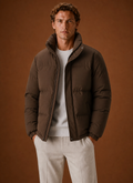 Men's oversized puffer jacket featuring a stylish quilted design, perfect for winter wear, providing warmth and comfort. 0